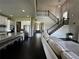 Open concept living room with hardwood floors, staircase, and view of kitchen at 2657 Gray Mill Way, Loganville, GA 30052
