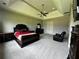 Spacious main bedroom with tray ceilings, ceiling fan, sitting area and luxury furnishings at 2657 Gray Mill Way, Loganville, GA 30052