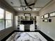 Well-lit home office featuring custom built-in shelving and a modern ceiling fan at 2657 Gray Mill Way, Loganville, GA 30052