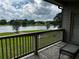 Peaceful lake view from the patio, enhanced by a small table for outdoor relaxation at 2657 Gray Mill Way, Loganville, GA 30052
