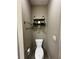 A cozy half-bathroom is decorated with a small wooden shelf at 2657 Gray Mill Way, Loganville, GA 30052
