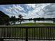 Stunning lake view from a balcony, complemented by lush greenery and a serene atmosphere at 2657 Gray Mill Way, Loganville, GA 30052