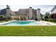Inviting backyard with a sparkling pool, covered patio, and well-manicured lawn perfect for outdoor living at 5440 Old Haven Ct, Cumming, GA 30041