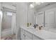 Modern bathroom featuring a double vanity, a shower-tub combination, and neutral decor at 5440 Old Haven Ct, Cumming, GA 30041