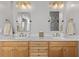 Bathroom features double sinks with marble countertops, wood cabinets, and updated fixtures at 5440 Old Haven Ct, Cumming, GA 30041