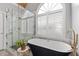 Stylish primary bathroom features a modern stand-alone tub next to a marble shower with a rain shower head at 5440 Old Haven Ct, Cumming, GA 30041