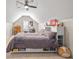 Cozy bedroom with sloped ceilings, a ceiling fan, and a built-in headboard with shelving at 5440 Old Haven Ct, Cumming, GA 30041
