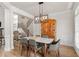 Elegant dining area with a modern chandelier, stylish furniture, and hardwood floors at 5440 Old Haven Ct, Cumming, GA 30041