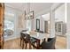 Elegant dining area featuring a marble table, modern chandelier and wainscotting at 5440 Old Haven Ct, Cumming, GA 30041