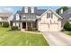 Charming two-story home with a well-manicured lawn and a classic colonial design at 5440 Old Haven Ct, Cumming, GA 30041