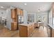 Eat-in kitchen with granite countertops, stainless steel appliances, hardwood floors, and backyard access at 5440 Old Haven Ct, Cumming, GA 30041