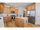 Well-lit kitchen with stainless steel appliances, a wooden island, and plentiful wooden cabinetry at 5440 Old Haven Ct, Cumming, GA 30041