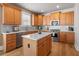 Eat-in kitchen with custom cabinets, granite countertops, stainless steel appliances, and a functional island at 5440 Old Haven Ct, Cumming, GA 30041