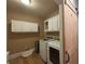 Well-equipped laundry room with front load washer and dryer and upper cabinets for extra storage at 5440 Old Haven Ct, Cumming, GA 30041