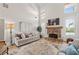 Bright living room with a stone fireplace, hardwood floors, and high ceilings at 5440 Old Haven Ct, Cumming, GA 30041