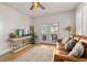 Comfortable living room featuring a plush leather sofa and access to the backyard at 5440 Old Haven Ct, Cumming, GA 30041
