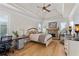 Main bedroom features a tray ceiling, hardwood floors, a fireplace, and plantation shutters at 5440 Old Haven Ct, Cumming, GA 30041