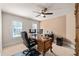 Bright office space with a large desk, neutral carpet, and a ceiling fan at 5440 Old Haven Ct, Cumming, GA 30041