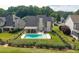 Backyard pool with covered patio, manicured lawn, and decorative fence bordering neighboring houses at 5440 Old Haven Ct, Cumming, GA 30041