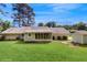 Back of home featuring a screened-in porch and a large yard perfect for outdoor activities and relaxation at 6 Fairfield Dr, Ellenwood, GA 30294