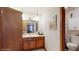 Bathroom featuring a wood door, white wallpaper, and wood cabinet at 6 Fairfield Dr, Ellenwood, GA 30294