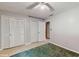 A bedroom with light grey walls, closet doors, neutral carpet, and tile floors at 6 Fairfield Dr, Ellenwood, GA 30294