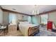 Bright bedroom with chandelier, tile floors, three large windows, and warm paint at 6 Fairfield Dr, Ellenwood, GA 30294
