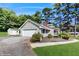 Home featuring an attached garage, tidy landscaping and mature trees that provide ample shade at 6 Fairfield Dr, Ellenwood, GA 30294