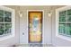 Welcoming front entry featuring a glass door, sidelight windows and neutral colored siding at 6 Fairfield Dr, Ellenwood, GA 30294