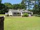 Charming one-story home featuring a lush lawn, attached garage, and inviting front porch at 6 Fairfield Dr, Ellenwood, GA 30294