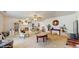 Open living room featuring neutral carpet, built-in bookshelves, chairs, and decorative accents at 6 Fairfield Dr, Ellenwood, GA 30294