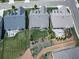 Aerial view of three homes showing backyard patios, landscaped yards, and well-maintained lawns at 603 Canyon Overlook, Canton, GA 30114