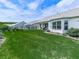 Well-maintained backyard with vibrant green grass, meticulous landscaping, and a view of neighboring homes at 603 Canyon Overlook, Canton, GA 30114