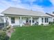 A view of the backyard and covered patio, complete with lush green lawn, landscaping, and a BBQ grill at 603 Canyon Overlook, Canton, GA 30114