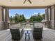 Inviting balcony with seating offers a serene view of the pool area surrounded by lush greenery at 603 Canyon Overlook, Canton, GA 30114