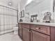 Bathroom with granite counter tops, wood cabinets, and a shower with a curtain at 603 Canyon Overlook, Canton, GA 30114