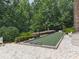 Well-maintained bocce court surrounded by lush landscaping, perfect for outdoor recreation at 603 Canyon Overlook, Canton, GA 30114