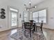 Cozy dining area features a round table, decorative rug, and ample natural light from the windows at 603 Canyon Overlook, Canton, GA 30114
