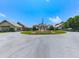 Community entrance featuring lush landscaping, circular driveway, and American flag at 603 Canyon Overlook, Canton, GA 30114