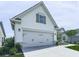 Angle showing the two-car garage of this home with white siding and stone veneer at 603 Canyon Overlook, Canton, GA 30114