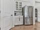 Kitchen area showing stainless steel refrigerator and white cabinets with glass inserts at 603 Canyon Overlook, Canton, GA 30114
