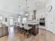 Bright kitchen features a large island with bar seating, modern appliances, and beautiful hardwood floors at 603 Canyon Overlook, Canton, GA 30114