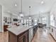 Spacious kitchen with island overlooking the living room and dining area, perfect for entertaining at 603 Canyon Overlook, Canton, GA 30114
