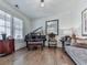 Elegant living room featuring a grand piano, comfortable seating, and stylish decor at 603 Canyon Overlook, Canton, GA 30114
