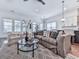 Open concept living room with comfortable seating, a glass coffee table, and decorative lighting at 603 Canyon Overlook, Canton, GA 30114