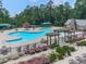 Stunning pool area featuring a unique design, seating, pergolas, and mature landscaping for a resort-like experience at 603 Canyon Overlook, Canton, GA 30114