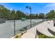 Enjoy a match on these well-maintained tennis courts with professional lighting and viewing area at 603 Canyon Overlook, Canton, GA 30114