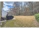 Backyard with treeline and patio space and barbeque with large grassy area at 2331 Flowerdale Ct, Douglasville, GA 30135