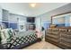 Comfortable bedroom with a TV, dresser, and complementary blue and white wall paint at 2331 Flowerdale Ct, Douglasville, GA 30135