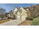 Side view of a two-story home featuring a two-car garage and landscaped yard at 2331 Flowerdale Ct, Douglasville, GA 30135